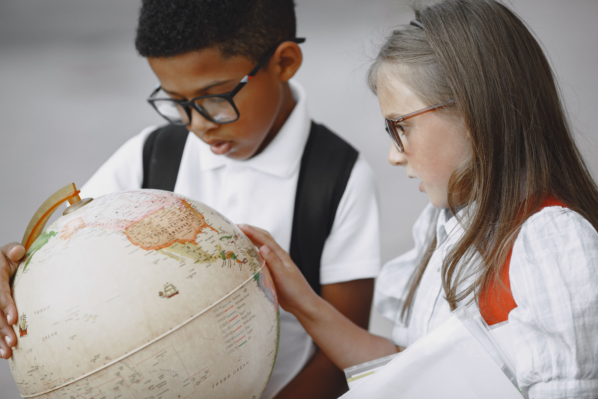 Children exploring a globe together