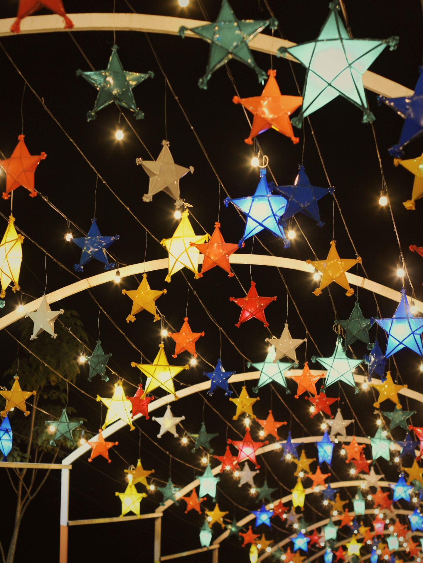 Colorful Filipino parol star lanterns lit up at night